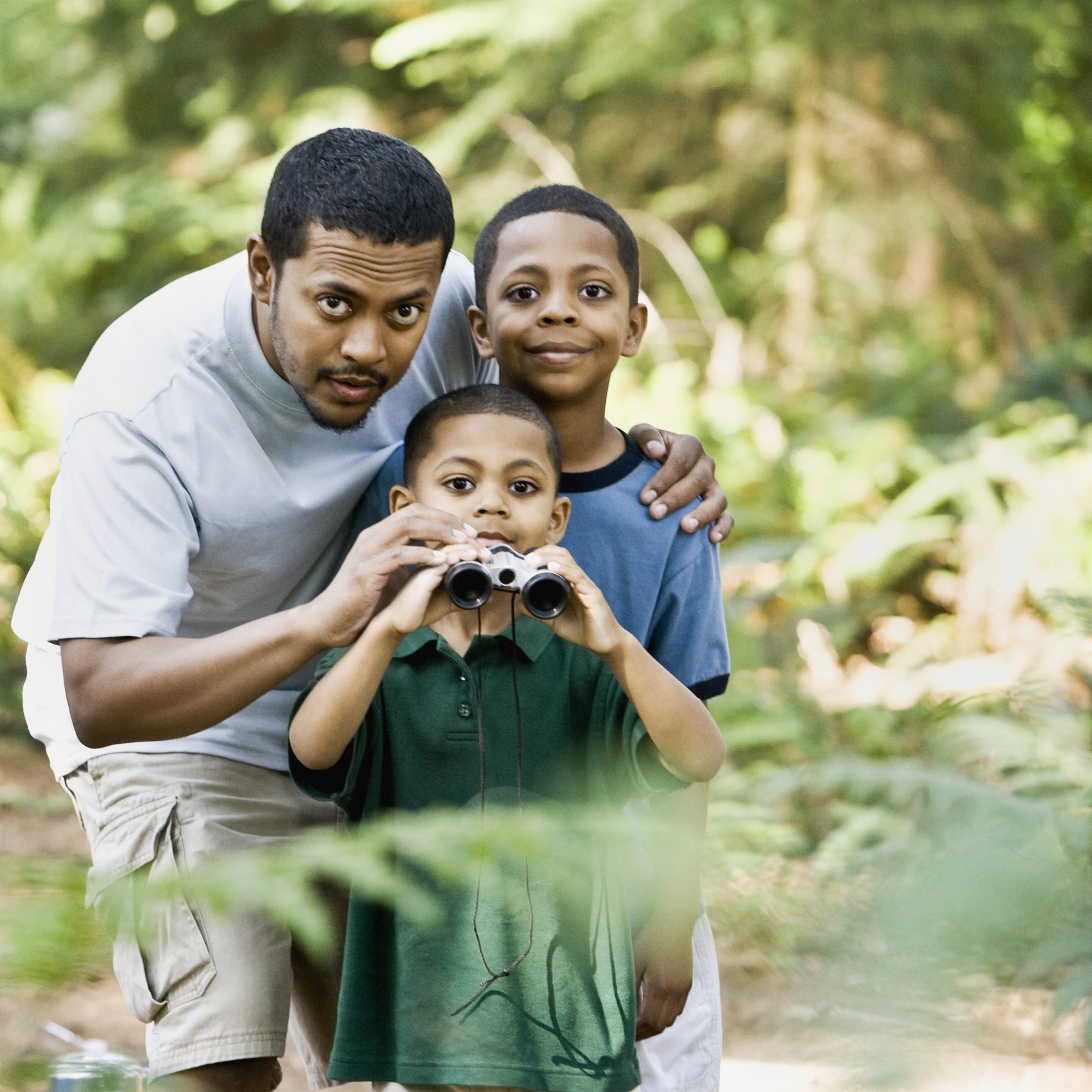 Pacific Islander father and sons with binoculars