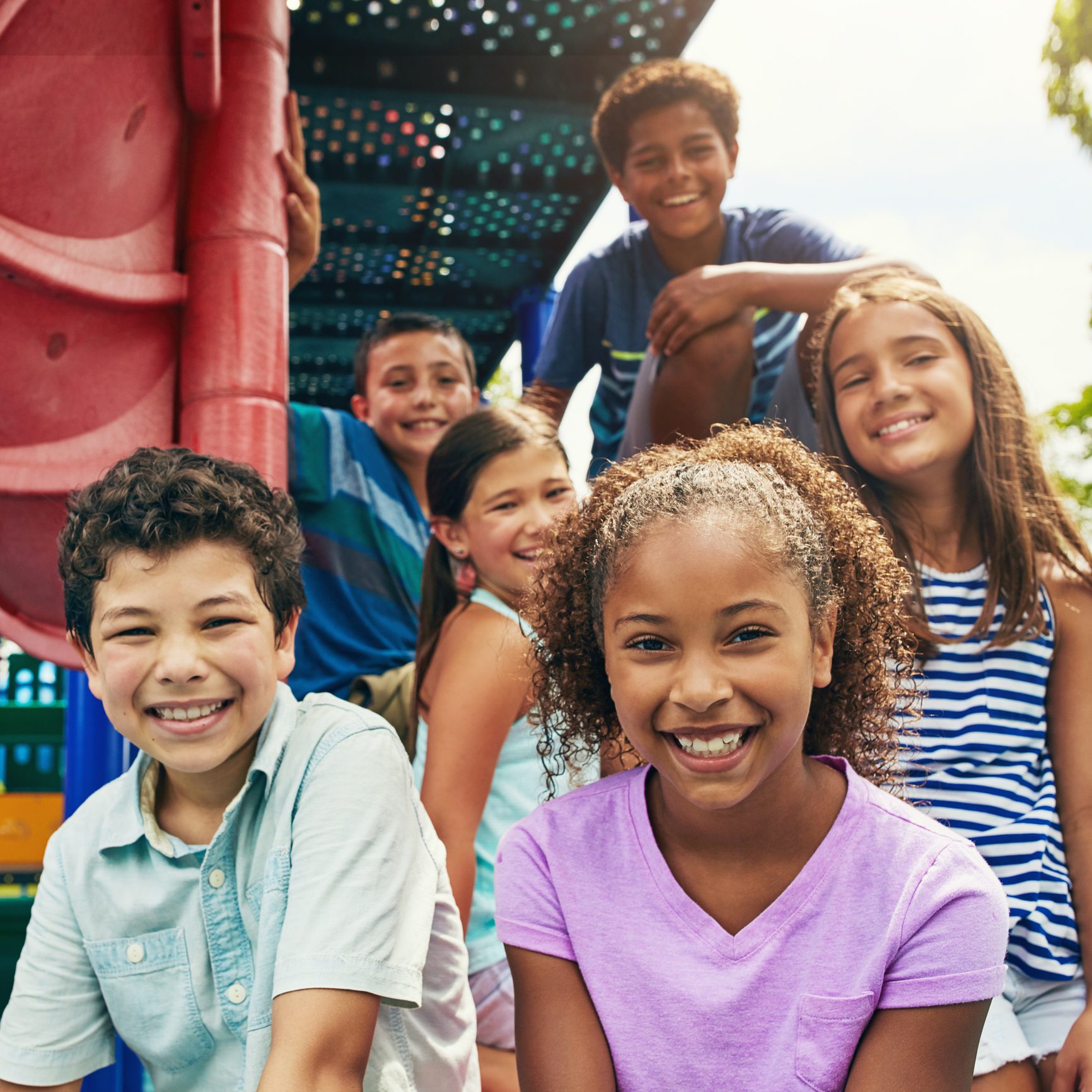 Shot of a group of young friends hanging out together at a playground